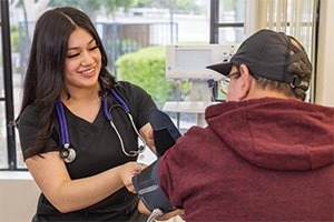nurse checking an elderly resident's blood pressure