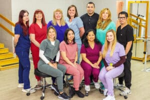 smiling employees in the rehab gym at sherwood oaks